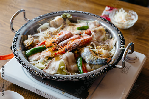 Nabe (Japanese hot pot dishes ) including prawns, salmon, pork, vegetables and mushrooms at the restaurant in Hokkaido, Japan.
