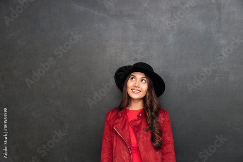 Happy young woman wearing hat looking aside. © Drobot Dean