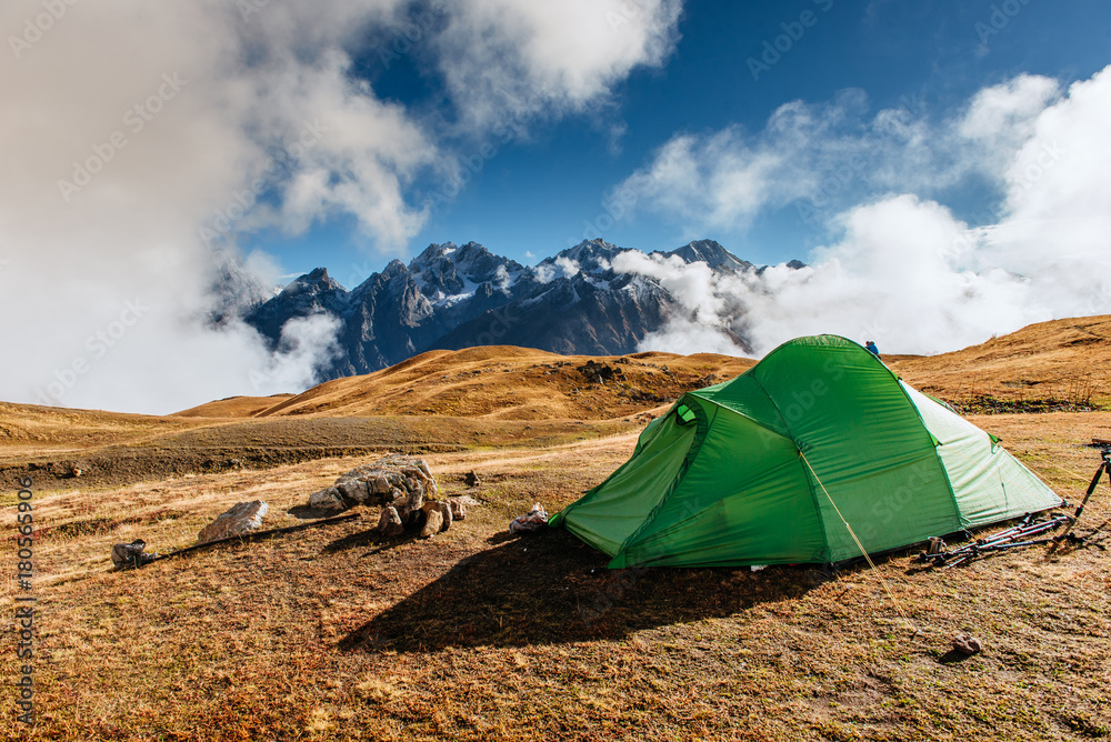 Tent green spread out on the pass Goulet. Georgia, Svaneti. Caucasus Mountains.