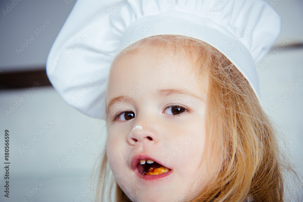 Baby boy with flour on nose in white chef hat Baby boy with flour on nose in white chef hat