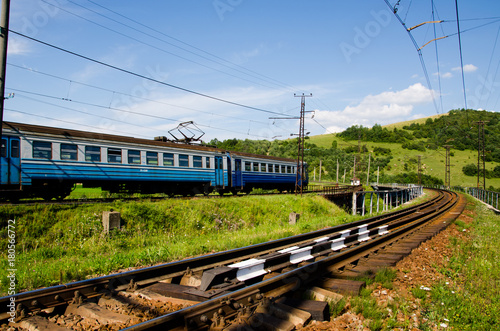 The train travels by rail through the mountains
