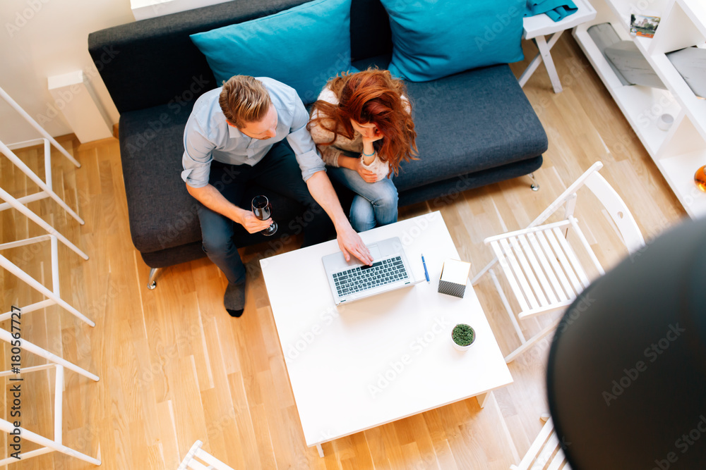 Beautiful couple working in a cosy living room Beautiful couple working in a cosy living room