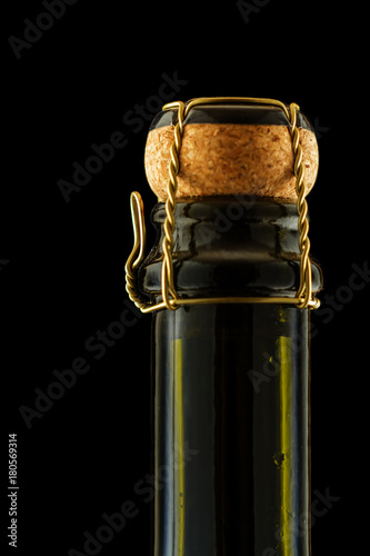 A bottle of sparkling wine. Black background. Macro. Place for text.
