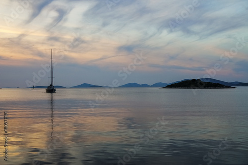 Sunset at sea with small yacht, beautiful nature landscape © michalsanca