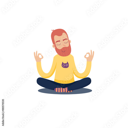 Red bearded man in a yellow sweater is meditating in the Lotus position.
