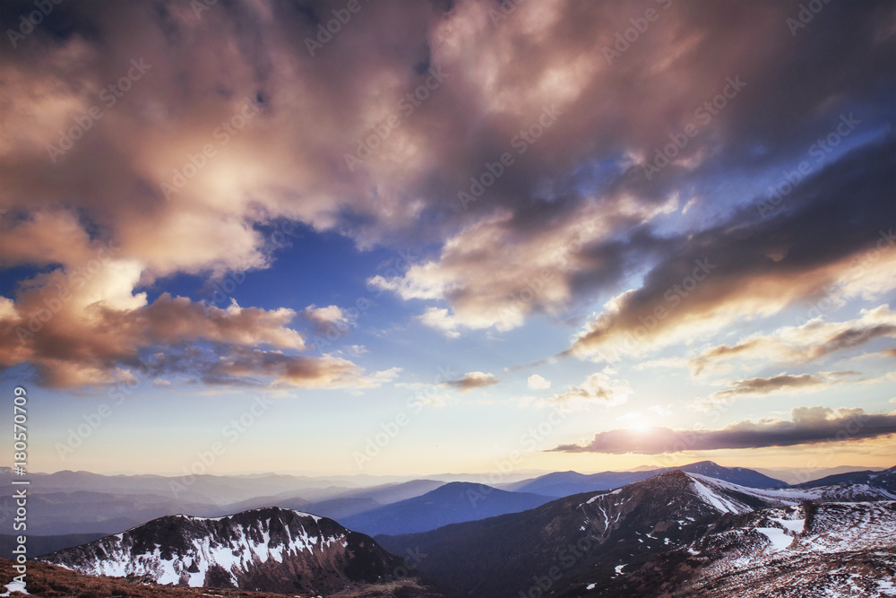 Colorful spring sunset over the mountain ranges in the national park Carpathians. Ukraine, Europe