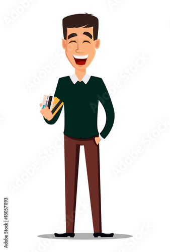 Young handsome smiling businessman in smart casual clothes holding credit cards