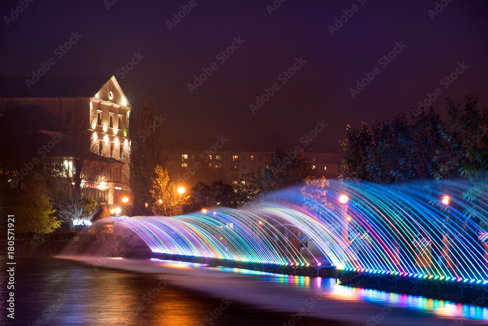 Beautiful magical landscape with colorful fountain jets on the waterfront in Ternopil, Ukraine, and Eurasia.