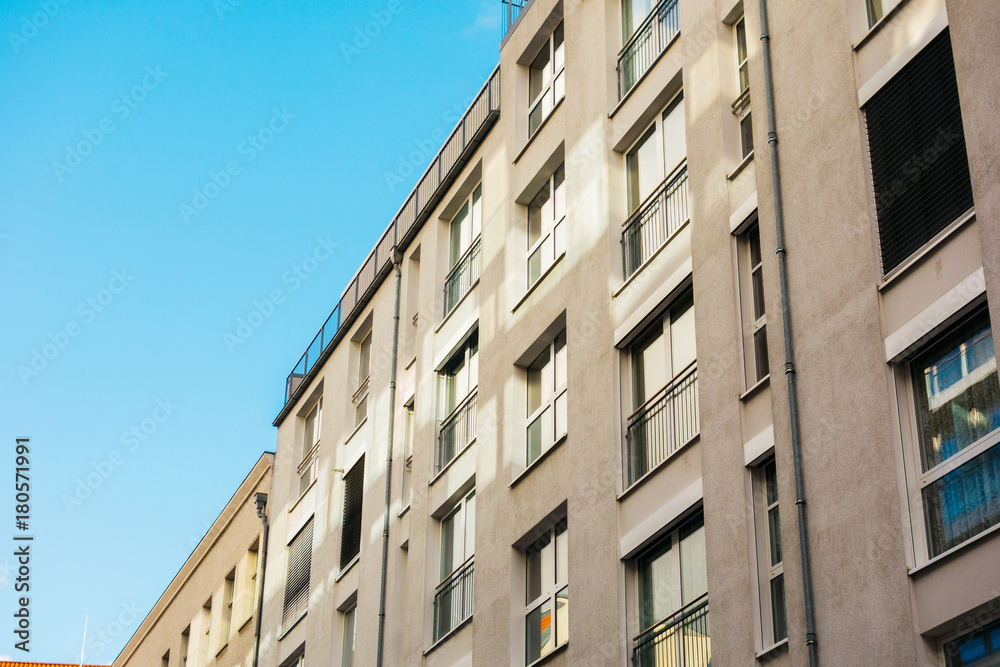 grey modern apartments with clean blue sky