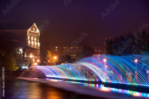 Obraz na płótnie Beautiful magical landscape with colorful fountain jets on the waterfront in Ternopil, Ukraine, and Eurasia. w salonie