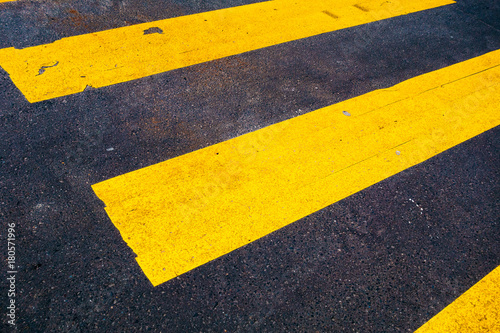 yellow zebra lines on darken street © Robert Herhold