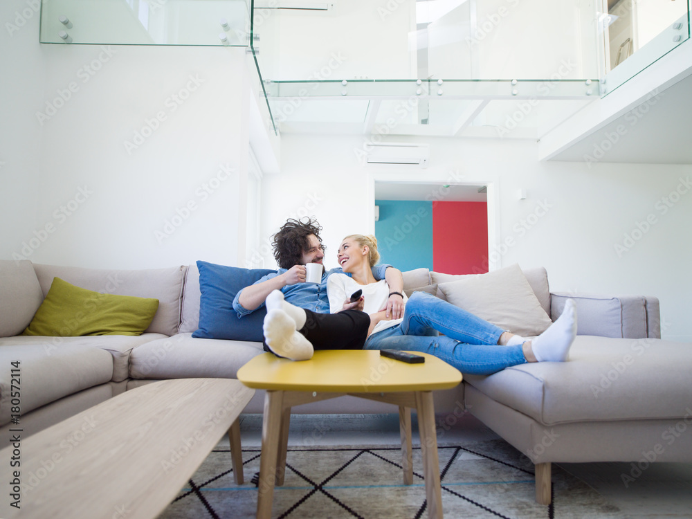 Young couple on the sofa watching television Young couple on the sofa watching television