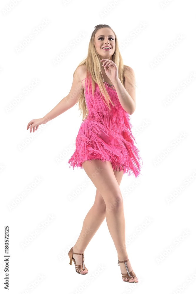 Blonde female Latino dancer smiling joyful and dancing salsa. Full body length portrait isolated on white studio background. Blonde female Latino dancer smiling joyful and dancing salsa. Full body length portrait isolated on white studio background.