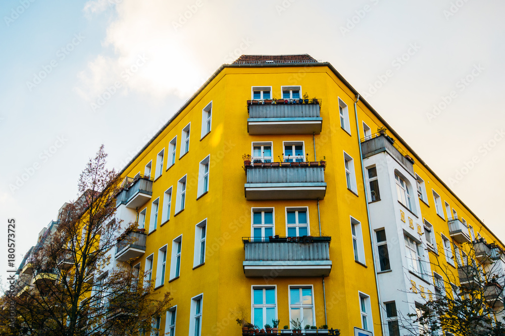 yellow corner building with grey balcony