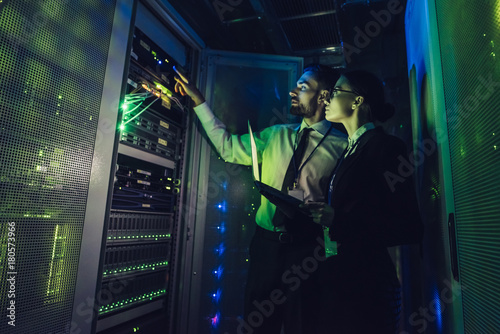 Man and woman in data centre photo