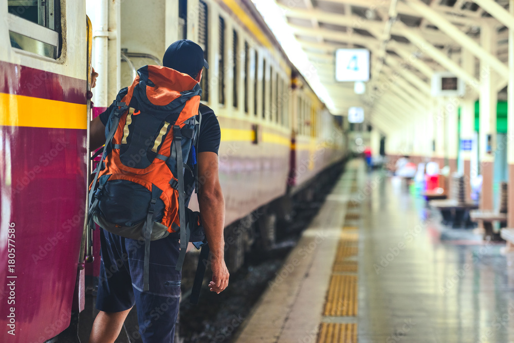 Fototapeta premium Man with backpackwaiting to travel by train