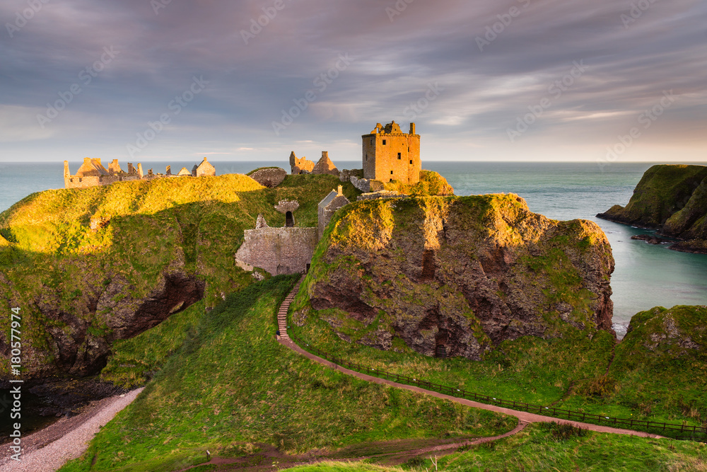 Golden Light on Dunnottar Castle / Dunnottar Castle is a ruined medieval fortress located upon a rocky headland on the north east coast of Scotland, near Stonehaven