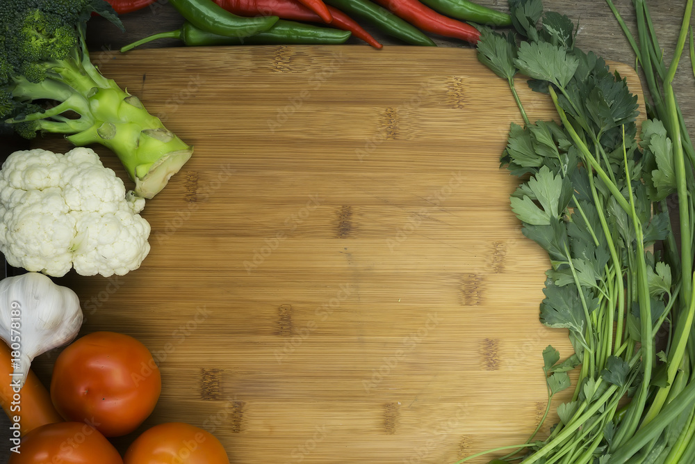 Top view of wooden cooking table with empty space and surrounded by various groceries. Cooking concept. Top view of wooden cooking table with empty space and surrounded by various groceries. Cooking concept.
