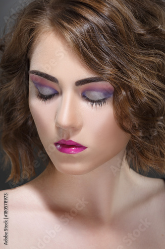 Fashion beauty portrait of a girl with a bright make-up in lilac tones.