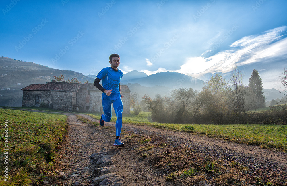 Fototapeta premium Runner athlete professional training on a mountain dirt