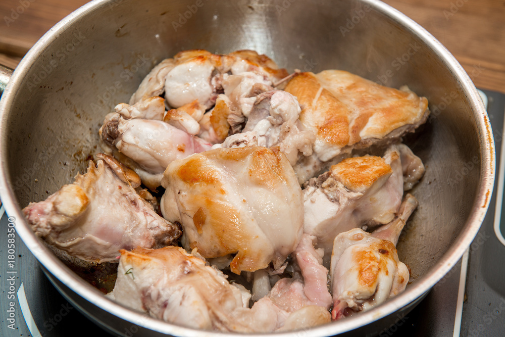 Frying pieces of the rabbit on the pan Frying pieces of the rabbit on the pan