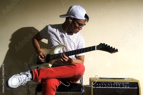 Teen playing an electric guitar