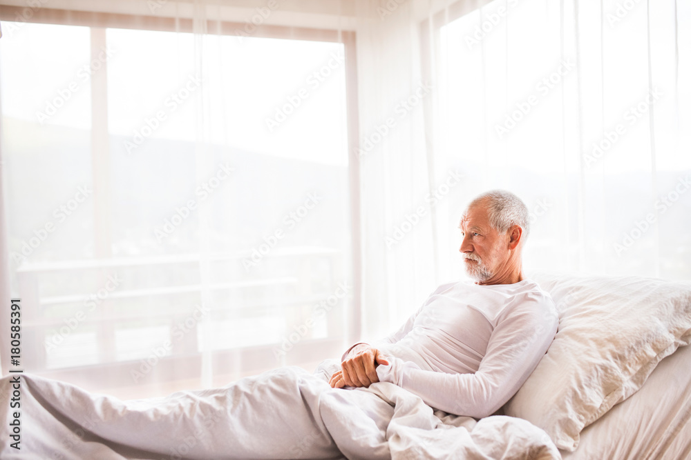 Senior man lying in bed at home. Senior man lying in bed at home.