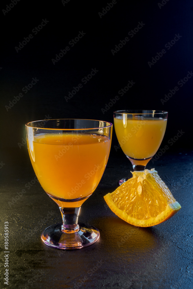 orange drink on a black background.