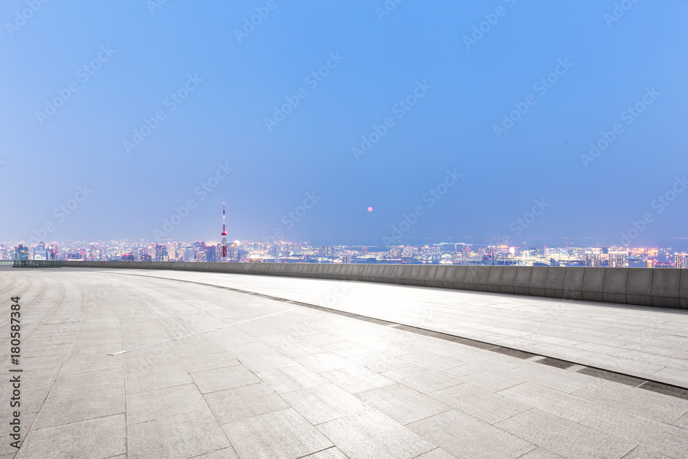 empty marble floor with modern cityscape at twilight