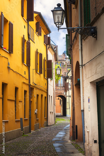 Ferrara, old narrow street, Italy