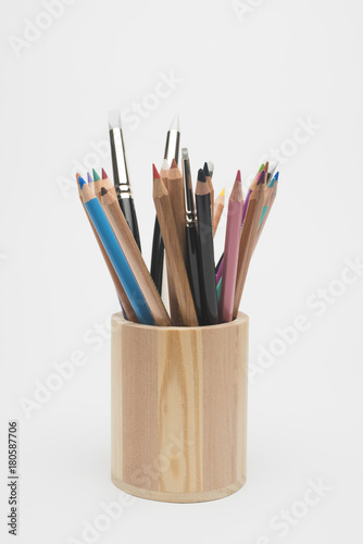 Wooden pencil holder with crayons and brushes