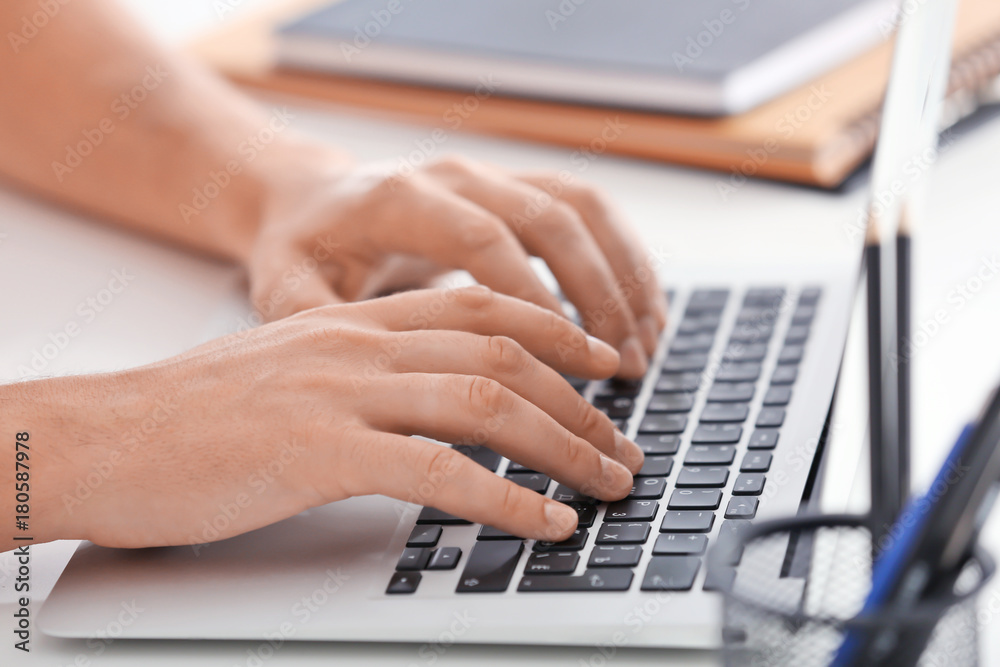 Male hands on laptop keyboard, closeup Male hands on laptop keyboard, closeup