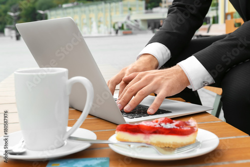 Young man using laptop at table