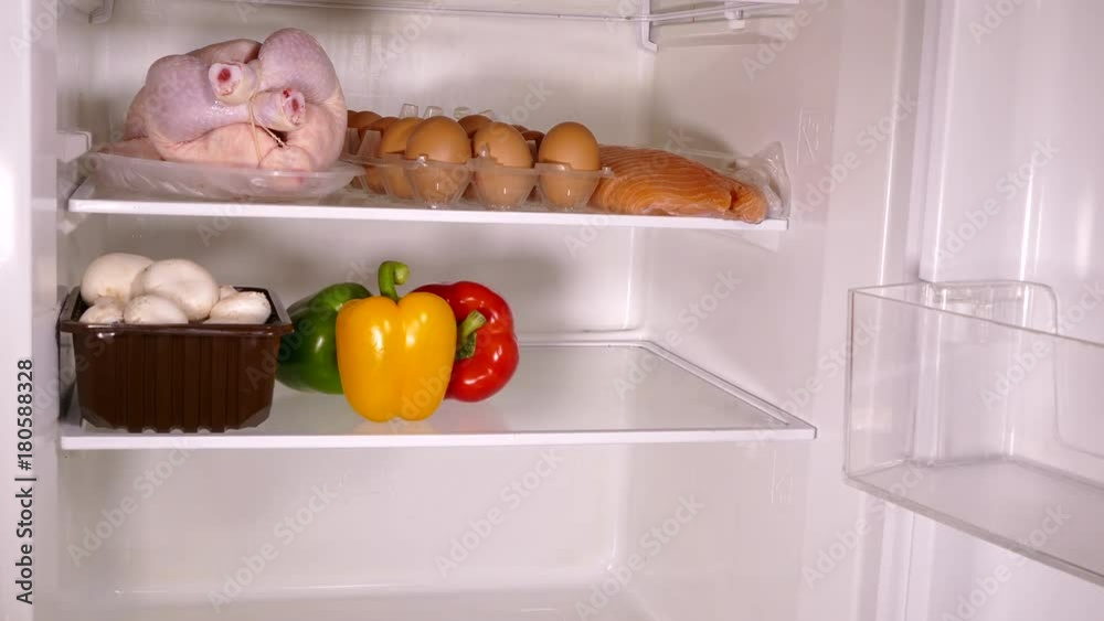 Timelapse of a fridge being stocked with fresh provisions. Timelapse of a fridge being stocked with fresh provisions.