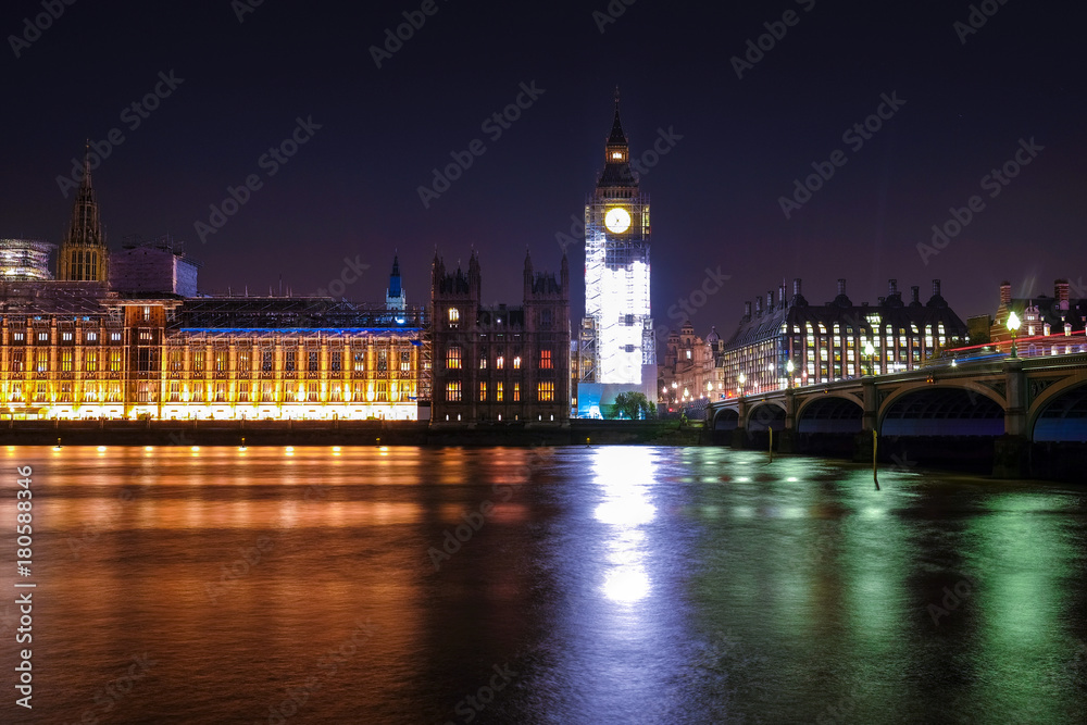 Naklejka premium Night scene with light trails on the Westminster bridge. Big Ben and House of Parliament in London, The United Kingdom of Great Britain.