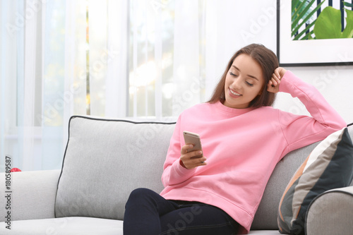 Young woman with mobile pho...
