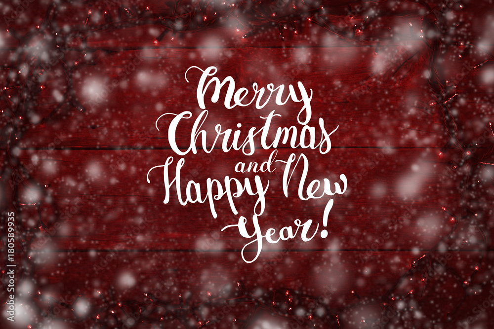 Garlands on a wooden background, red color is added. The inscription is added Merry Christmas and Happy New Year Garlands on a wooden background, red color is added. The inscription is added Merry Christmas and Happy New Year