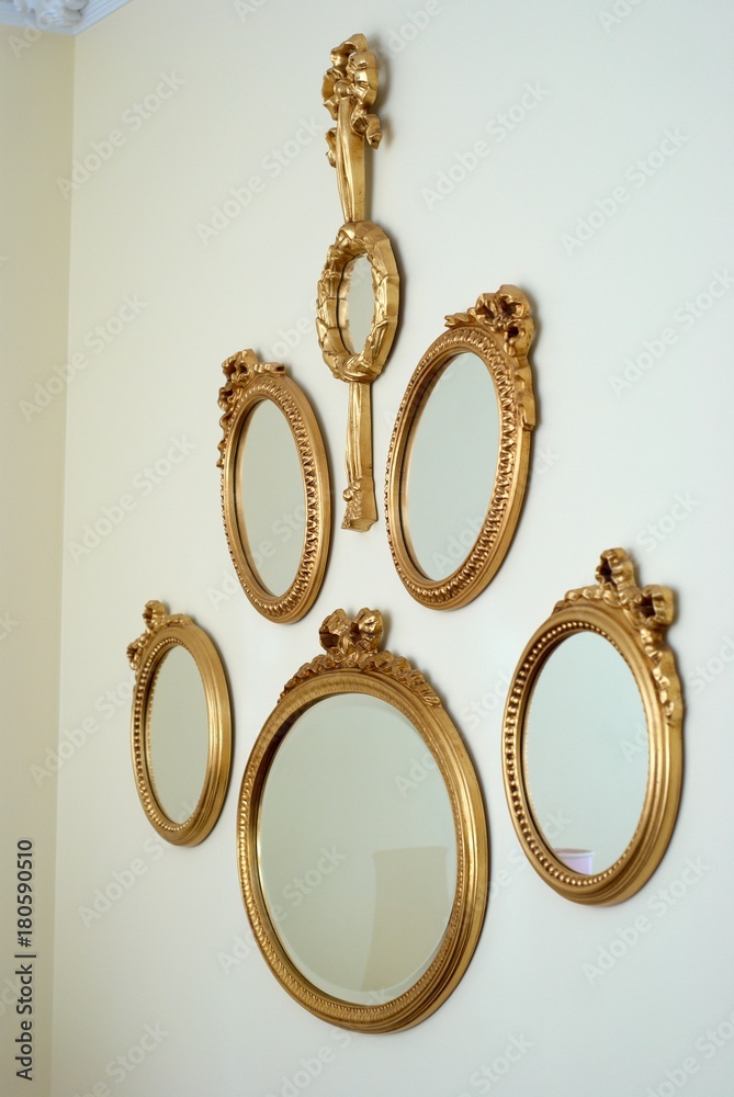 Oval mirrors in a golden frame