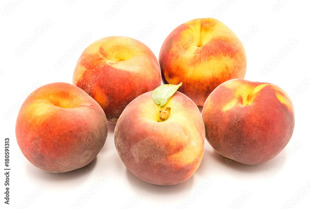 Group of five whole peaches, one with green leaf, isolated on white background. Group of five whole peaches, one with green leaf, isolated on white background.