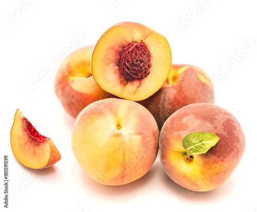 Group of peaches, whole with a green leaf, one half with a stone, one slice, isolated on white background.