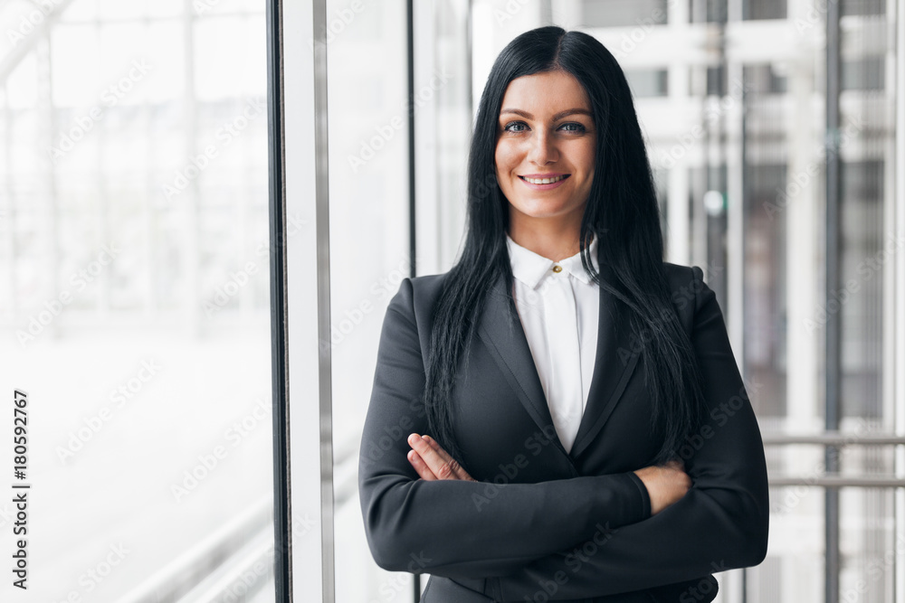 Successful confident business woman in an office setting Successful confident business woman in an office setting