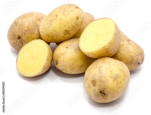 Group of whole potatoes and two halves isolated on white background.