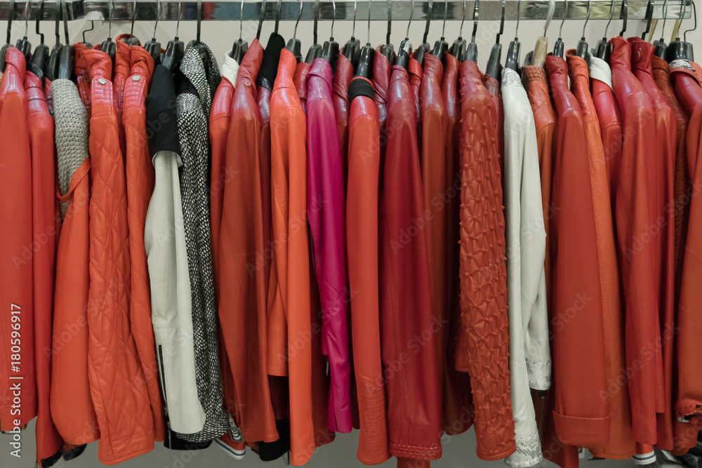 Rows of green and red leather jackets on the racks Rows of green and red leather jackets on the racks