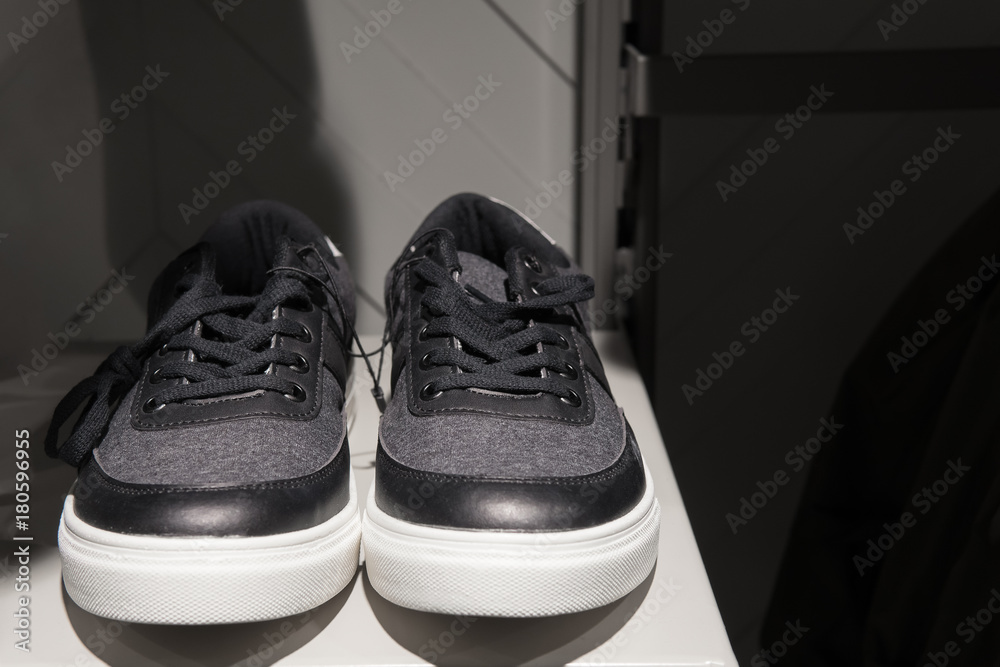 Showcase with black and white sneakers closeup