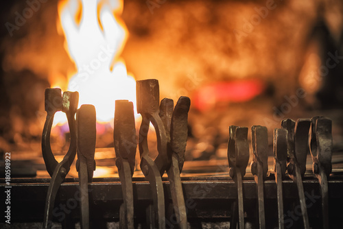 Fotografie Blacksmith furnace with burning coals, tools, and glowing hot metal workpieces