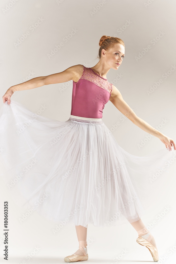 Naklejka premium ballerina in pink posing in full length