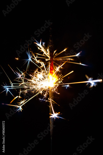 Burning sparkler isolated on black background blur