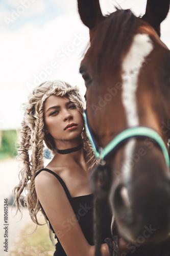 Beautiful young girl with brown horse