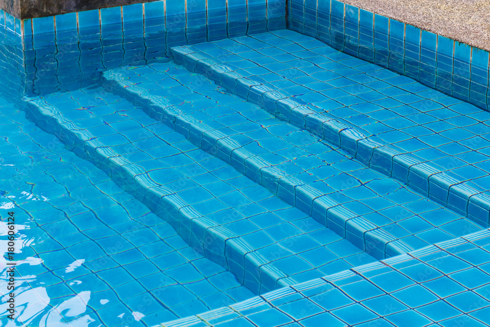 Swimming pool with a stone flooring beside it