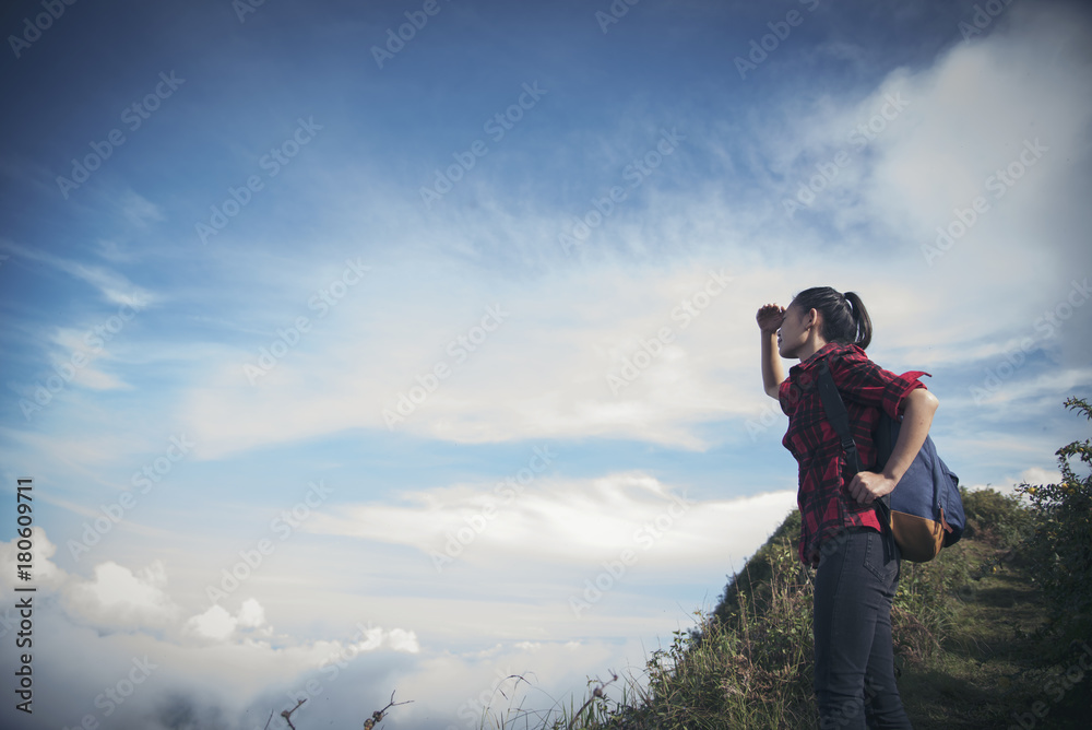 Freedom traveler woman standing with raised arms and enjoying a beautiful nature. Image with instagram filter